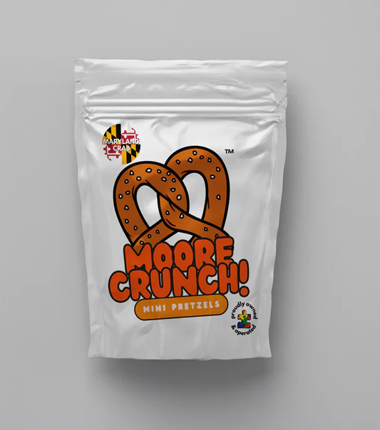 shiny white bag with cute picture of brown pretzel with orange words saying Moore Crunch Mini Pretzels Maryland Crab